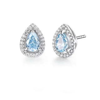 Pair of earrings with pear-shaped blue gemstones on a white background