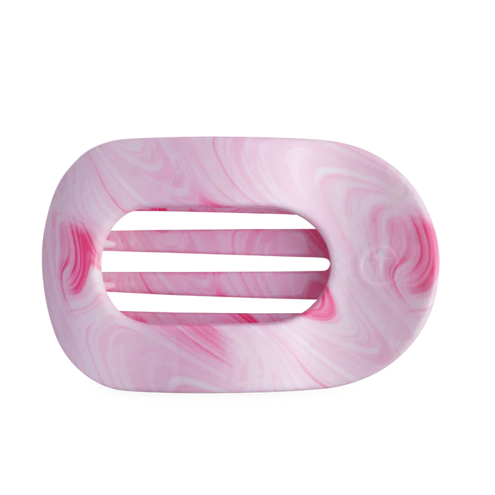 Pink and white marbled hair clip on a white background