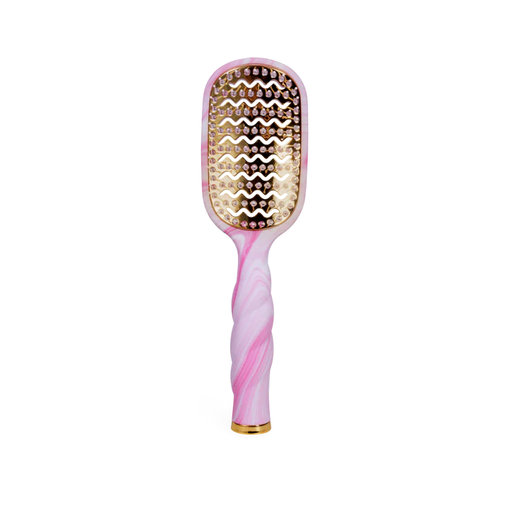 Pink and gold hairbrush on a white background
