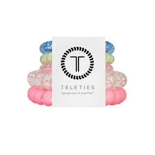 Set of colorful hair ties with a Teleties branded card on a white background