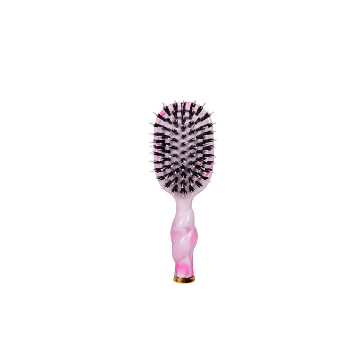 Hairbrush with pink handle and black bristles on a white background