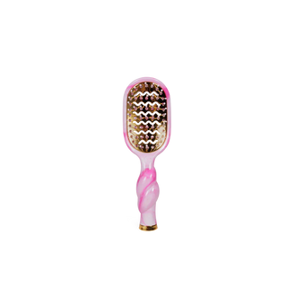 Pink and gold hairbrush on a white background