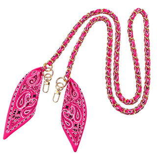 A bright pink and gold chain leash with two matching pointed leather pulls featuring a paisley pattern, shown on a plain white background.