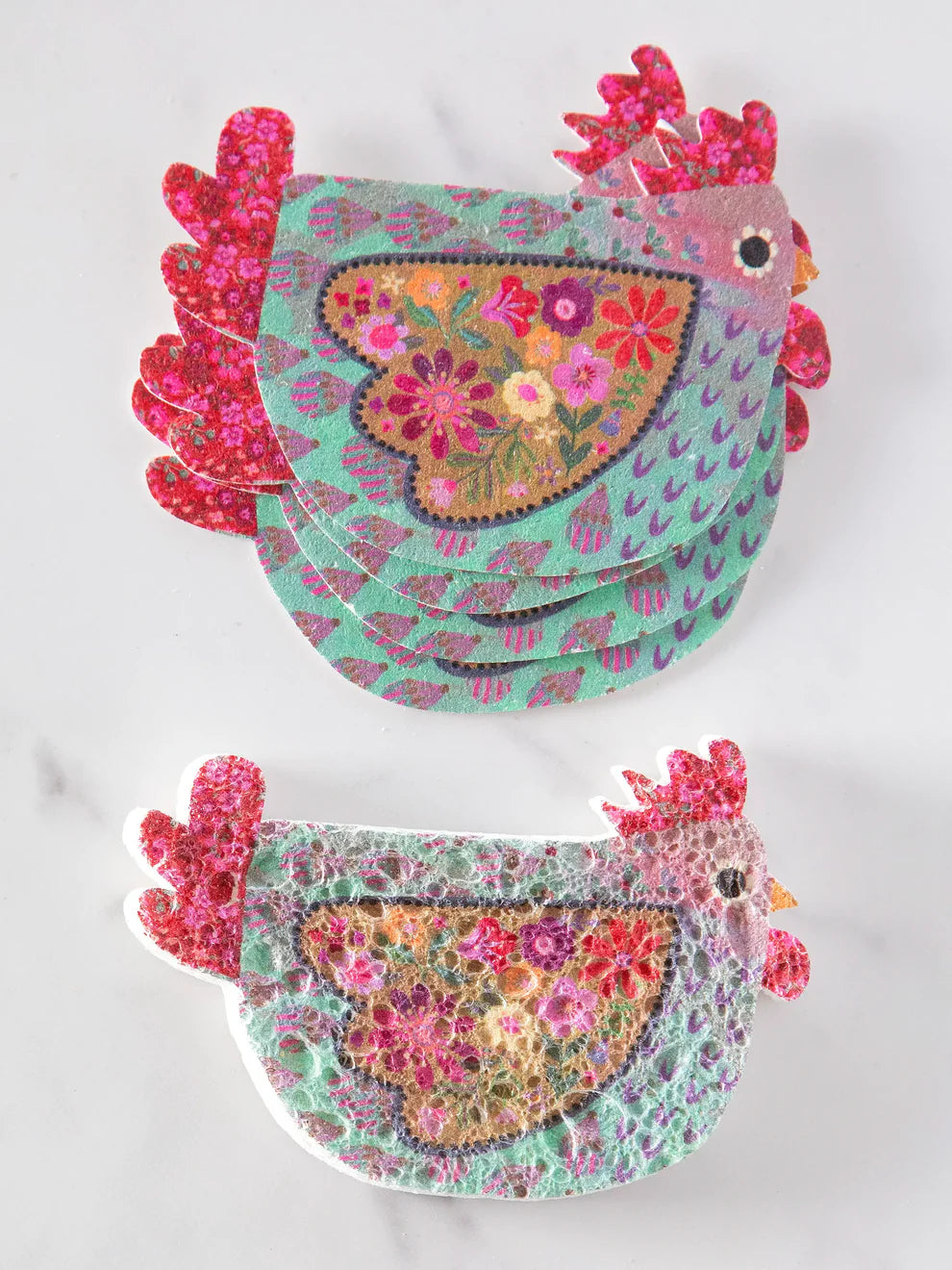 Colorful hen-shaped coasters with floral patterns on a white background