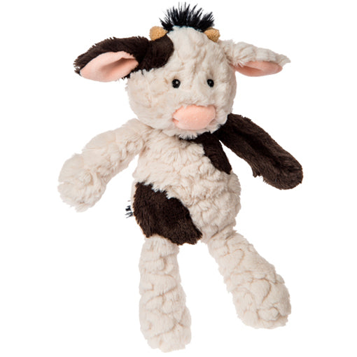 Plush cow toy on a white background