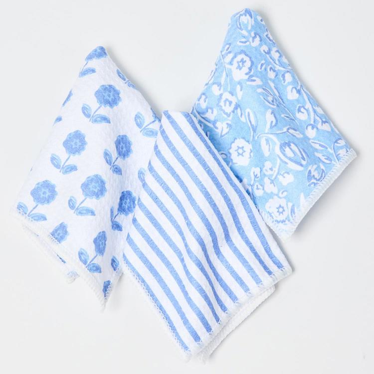 Three patterned handkerchiefs with blue floral, striped, and geometric designs on a white background.