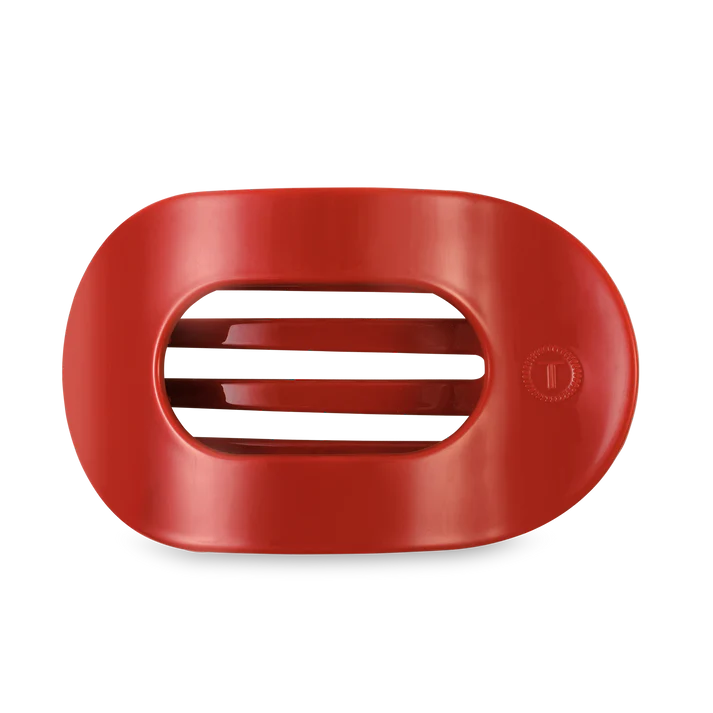 Red plastic component on a white background