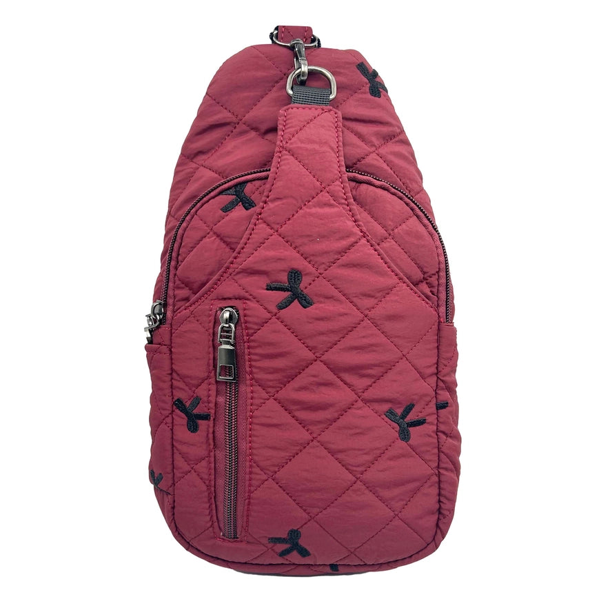 Red quilted sling bag with black accents on a white background