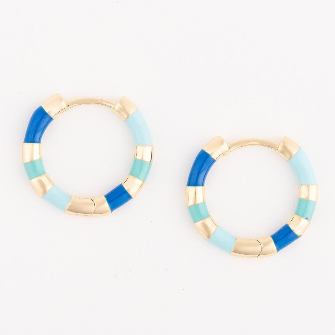 Pair of hoop earrings with blue and gold accents on a white background