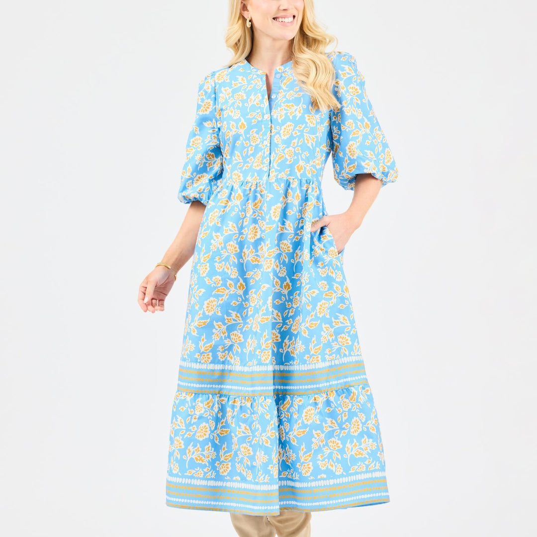 Woman wearing a blue floral dress on a white background