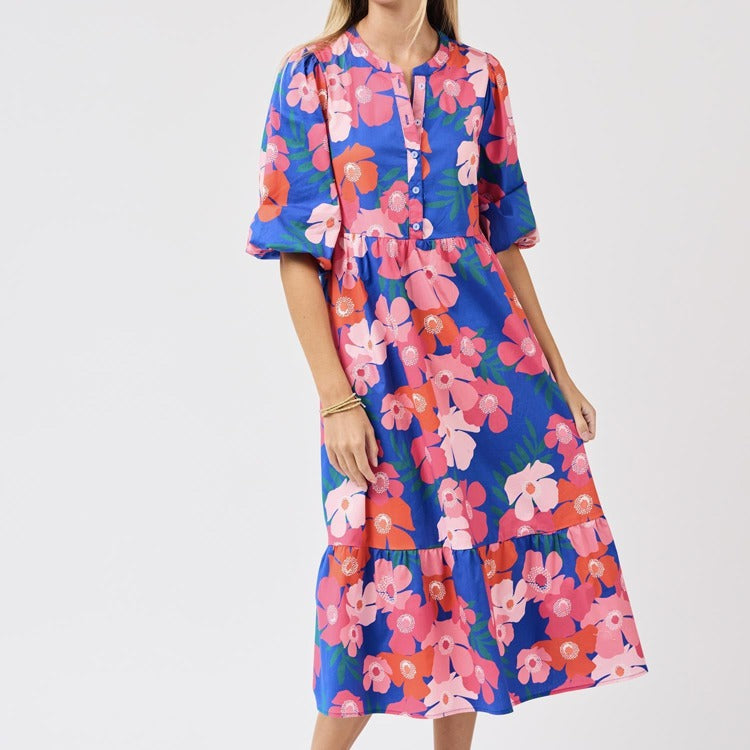 Woman wearing a colorful floral dress on a white background