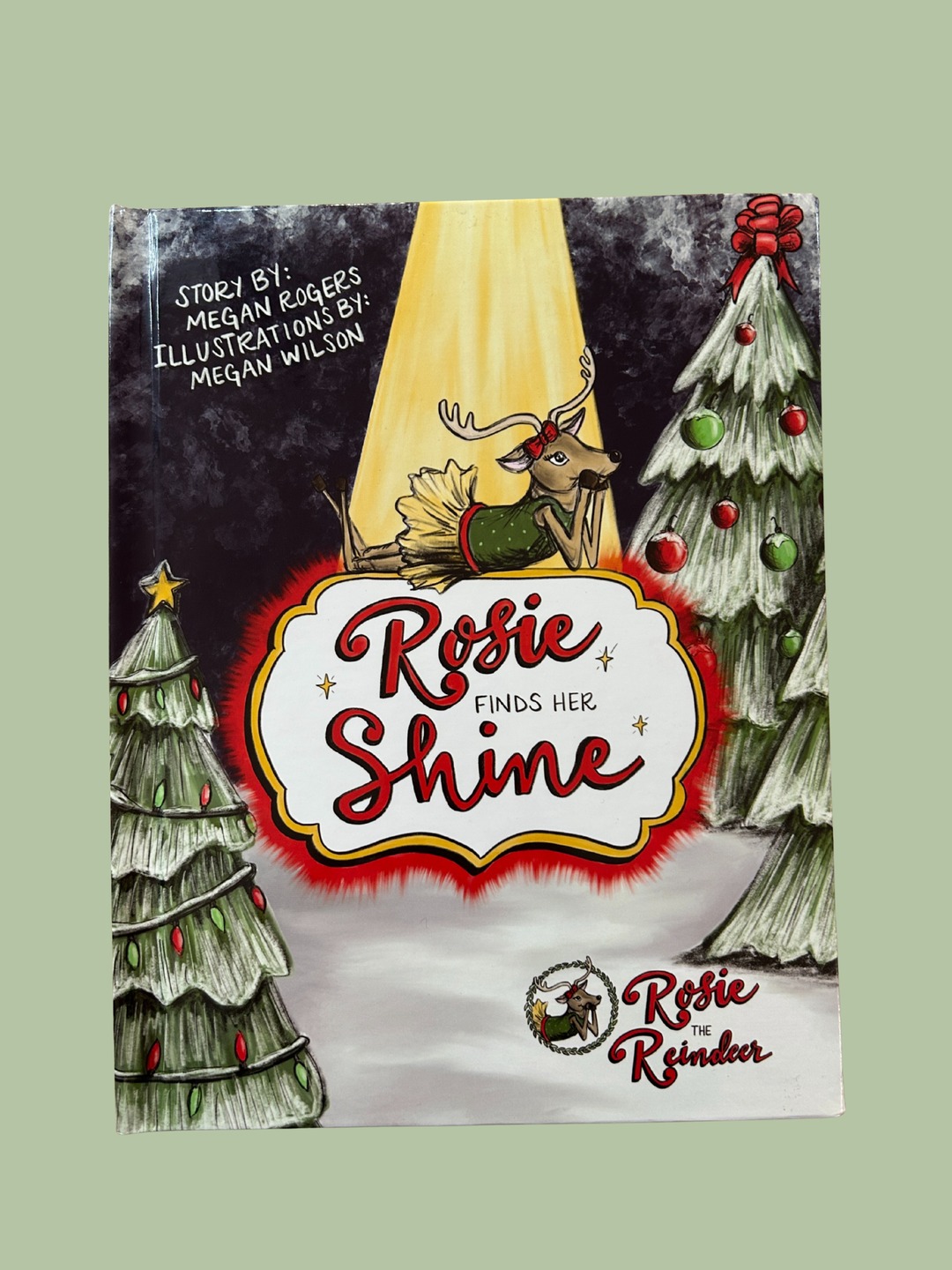 Book cover of 'Rosie Finds Her Shine' with a reindeer and Christmas trees.