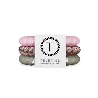 Set of pink and gray hair ties with 'Teleties' branding on a white background