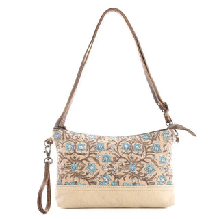 Floral patterned handbag with beige base on a white background