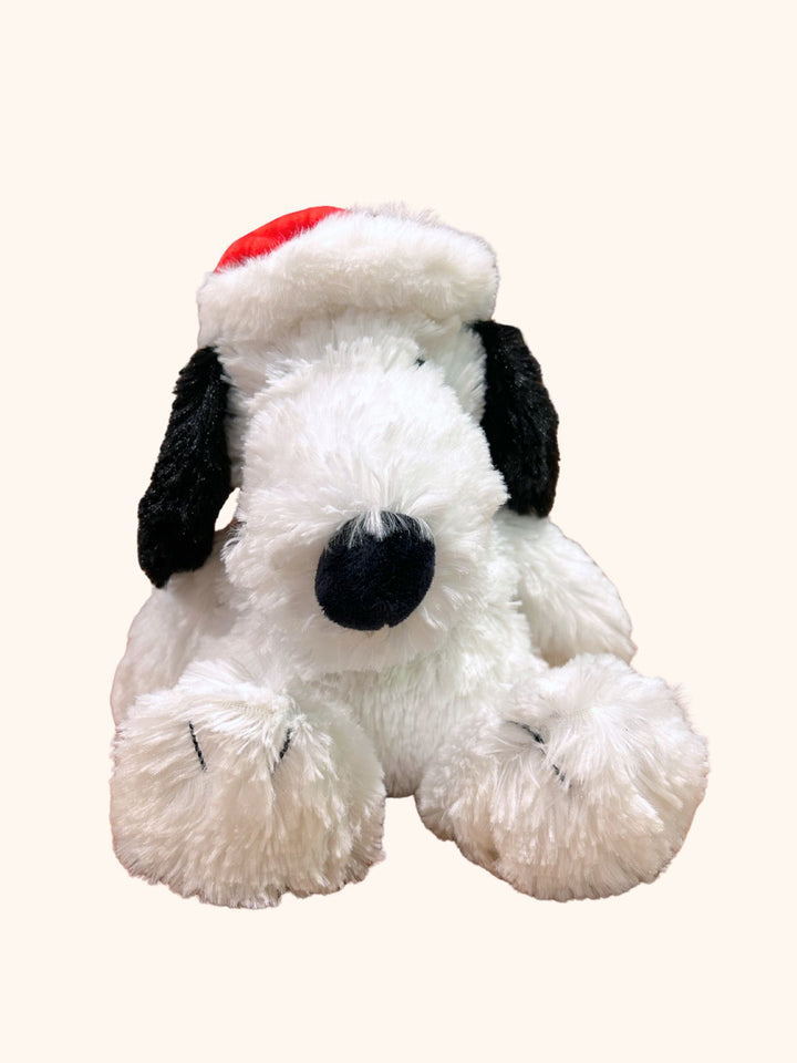 Plush dog toy with a Santa hat on a white background