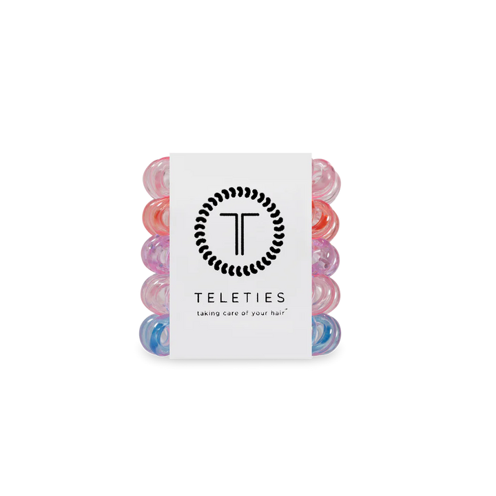 Set of colorful hair rollers with a Teleties branded card on a white background