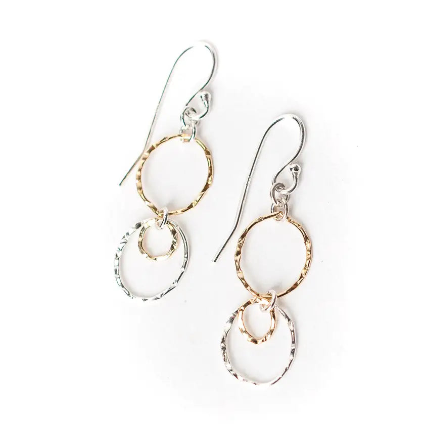 Pair of earrings with gold and silver loops on a white background
