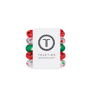Set of red and green hair ties with a Teleties branded card on a white background