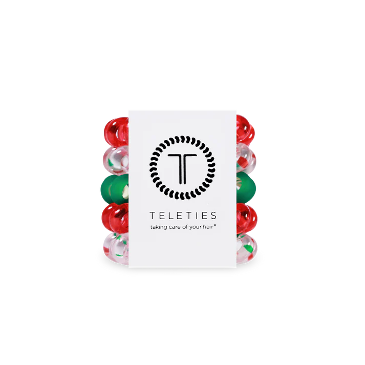 Set of red and green hair ties with a Teleties branded card on a white background
