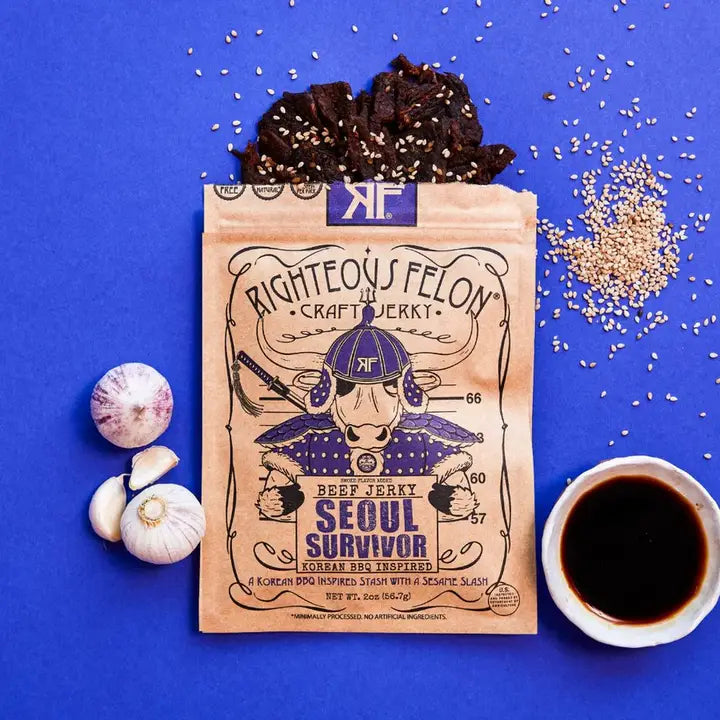 Righteous Felon Seoul Survivor beef jerky package on a blue background with ingredients and a cup of coffee.