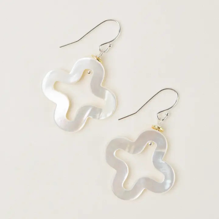Pair of star-shaped earrings on a light background