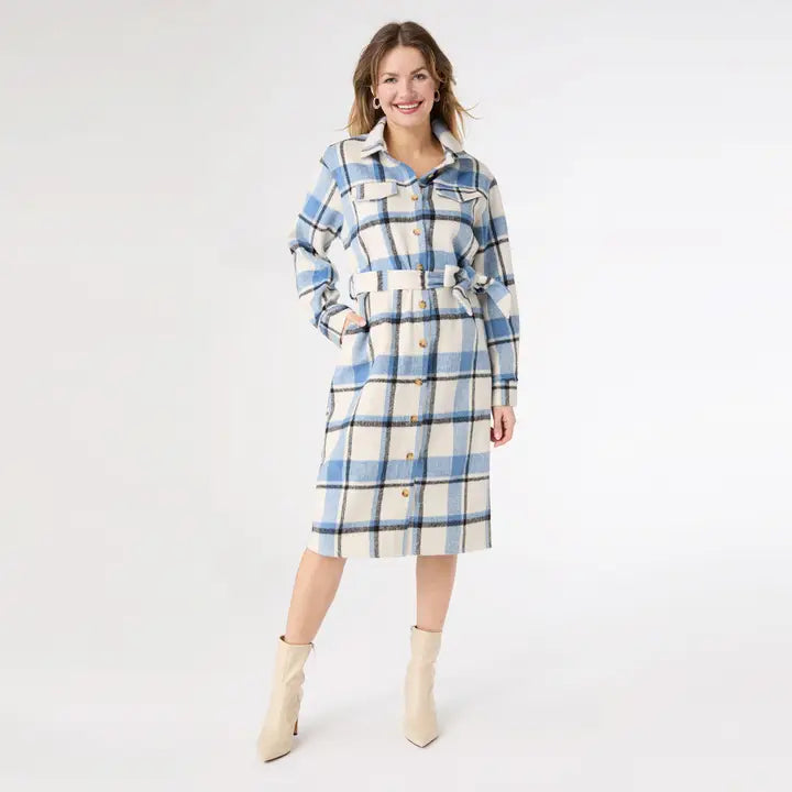 Woman wearing a blue and white plaid dress on a white background