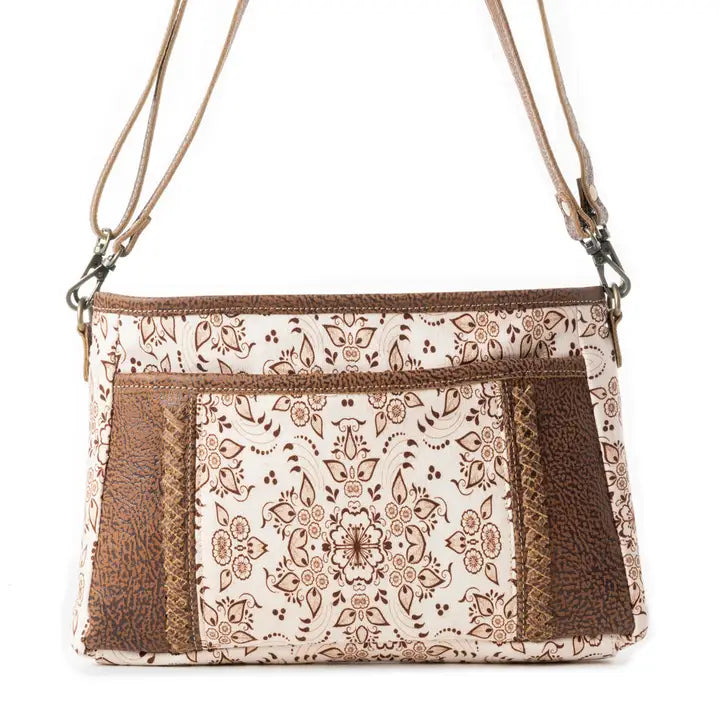 Patterned handbag with brown accents on a white background
