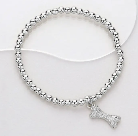 Silver beaded bracelet with a bone-shaped charm on a white background