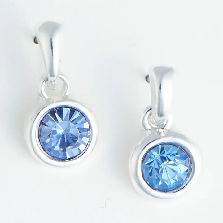 Silver earrings with blue gemstones on a white background