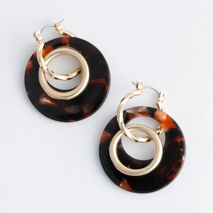 Tortoiseshell hoop earrings with gold rings on a white background