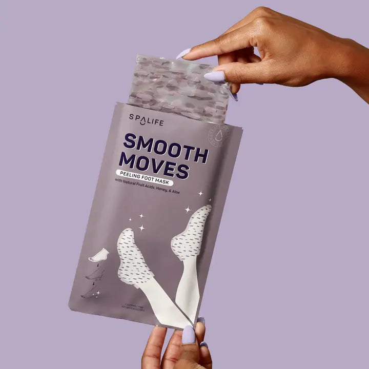 SpaLife Smooth Moves peeling foot mask packaging held by a hand against a purple background