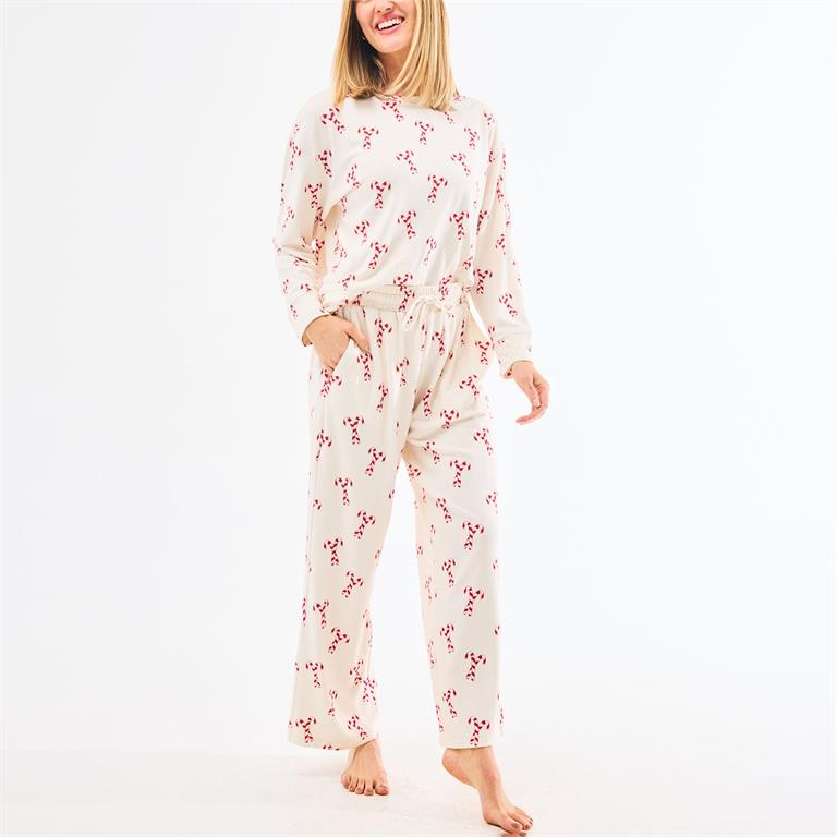 Woman wearing a floral pajama set on a white background