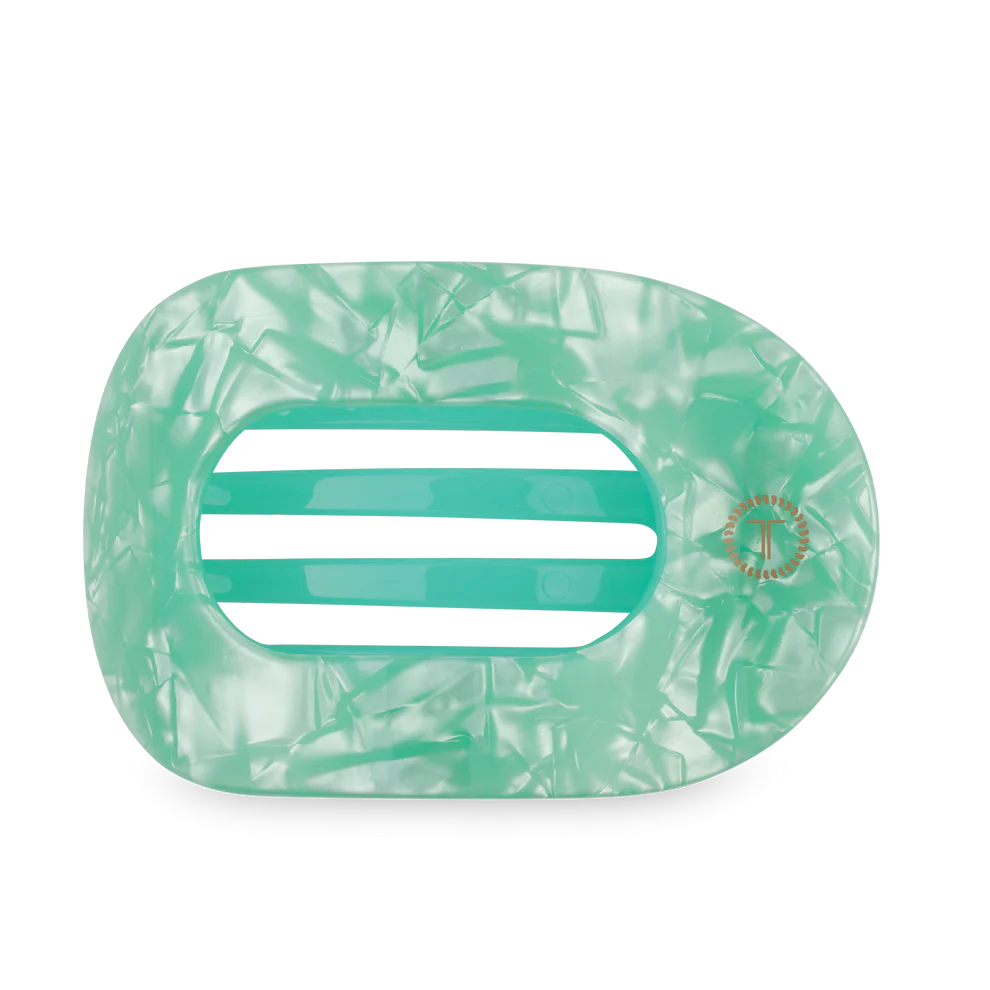 Green marbled hair clip on a white background