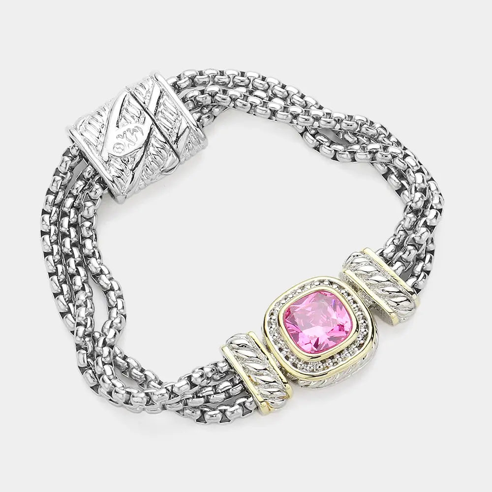 Silver bracelet with a pink gemstone on a white background