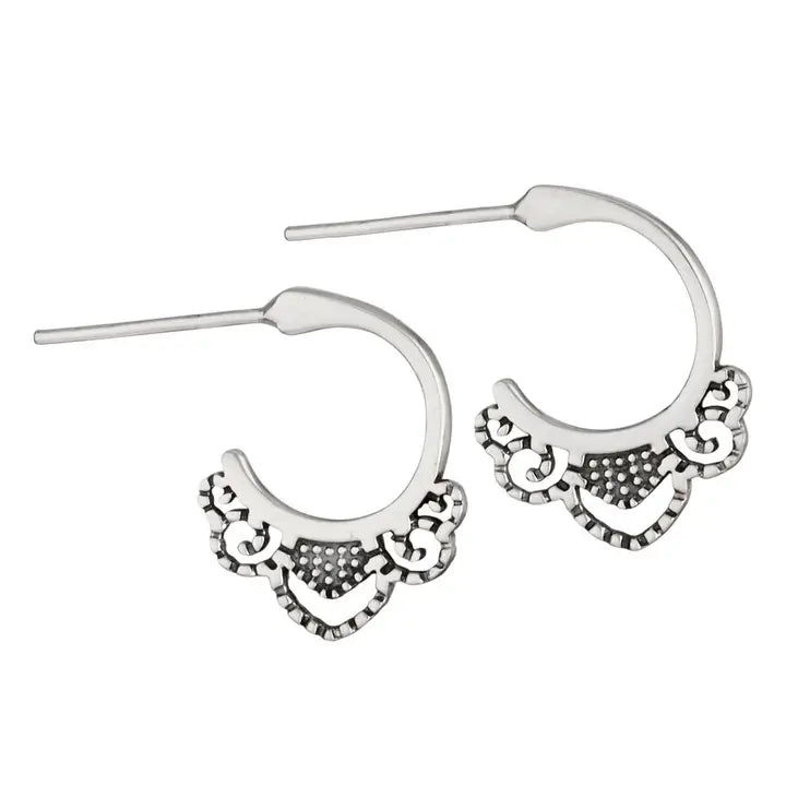 Silver hoop earrings with intricate designs on a white background