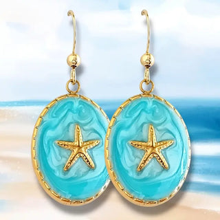 Blue enamel starfish dangle earrings with gold accents