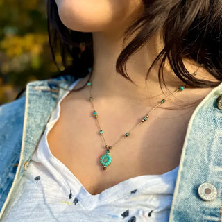 necklace with blue beads and sunflower charm