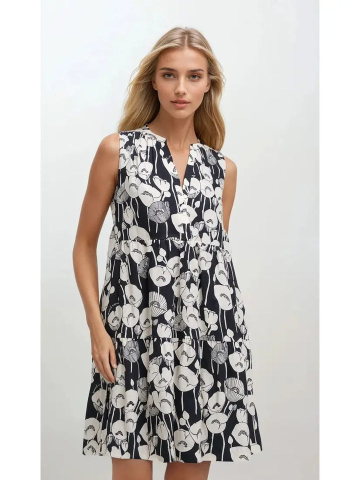woman wearing sleeveless black mini dress with white flower pattern