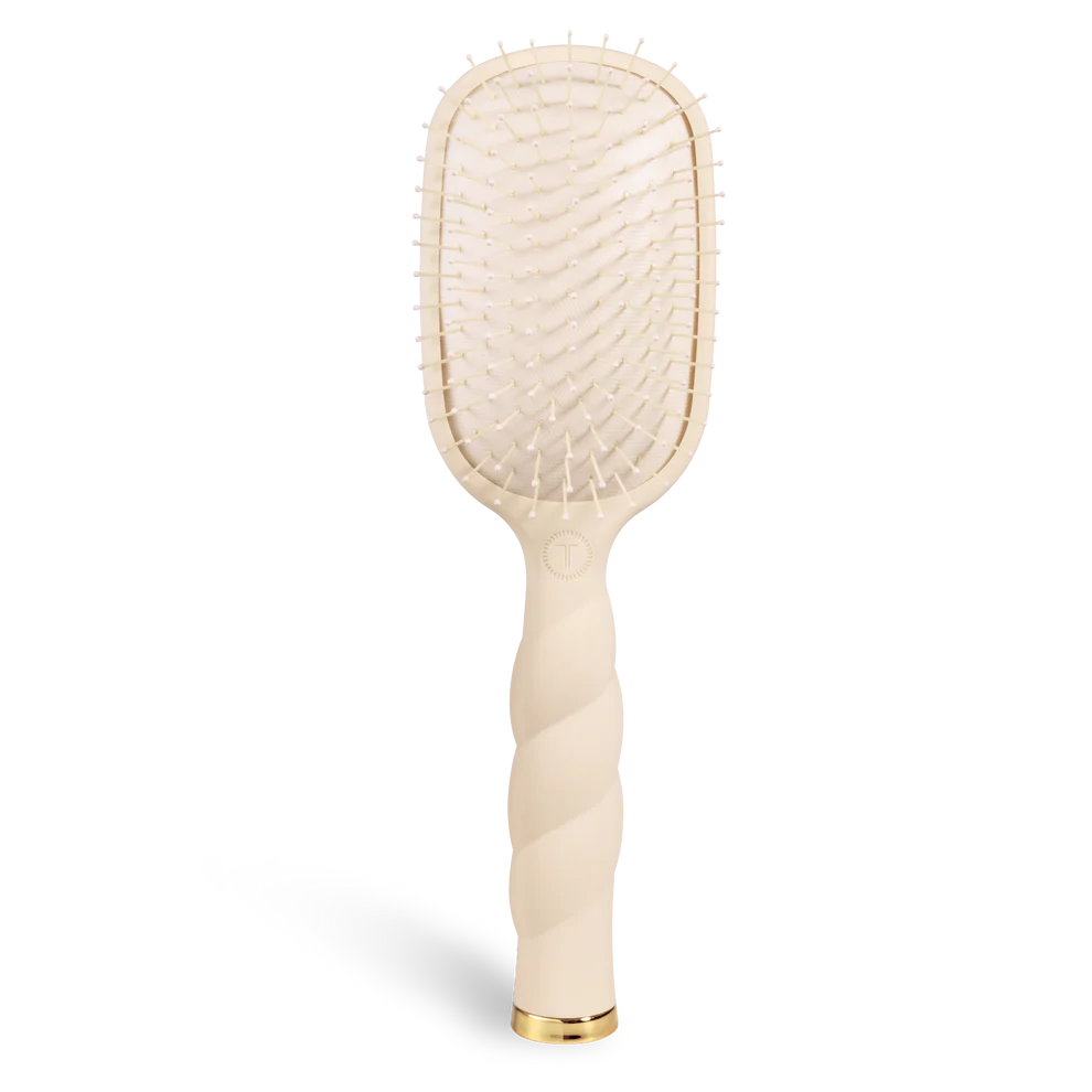 Beige paddle hairbrush on a white background