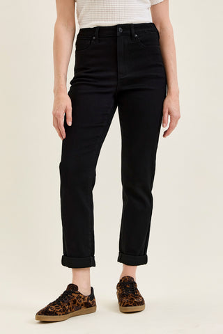 woman wearing slim black cuffed jeans
