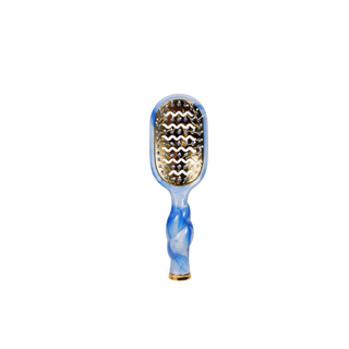 Paddle hairbrush with blue and gold design on a white background