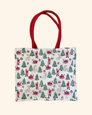 white bag Adorned with delightful illustrations of Santa, his reindeer, and a joyful sleigh