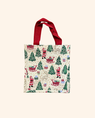 white bag Adorned with delightful illustrations of Santa, his reindeer, and a joyful sleigh