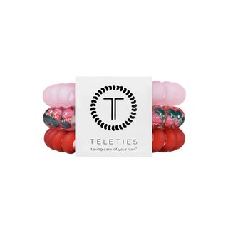 TELETIES branded spiral coil hair ties in pink, red, and a red and green tartan print