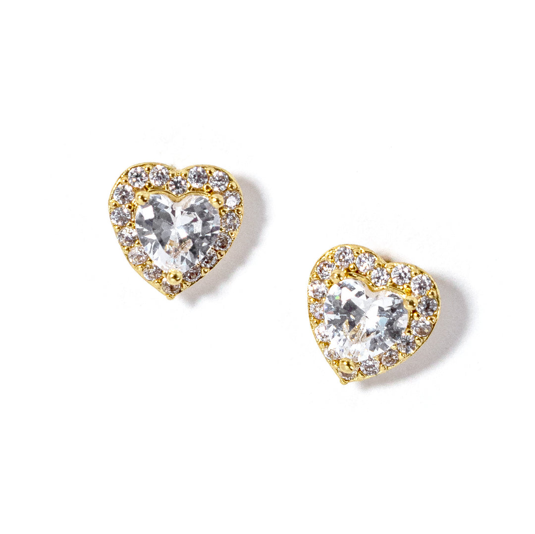 Heart-shaped earrings with clear gemstones and gold accents on a white background