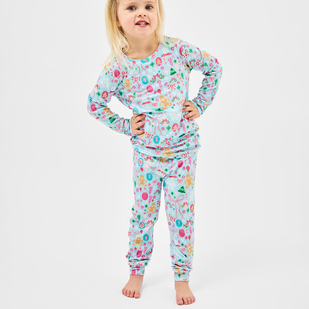 Child wearing a colorful pajama set on a white background