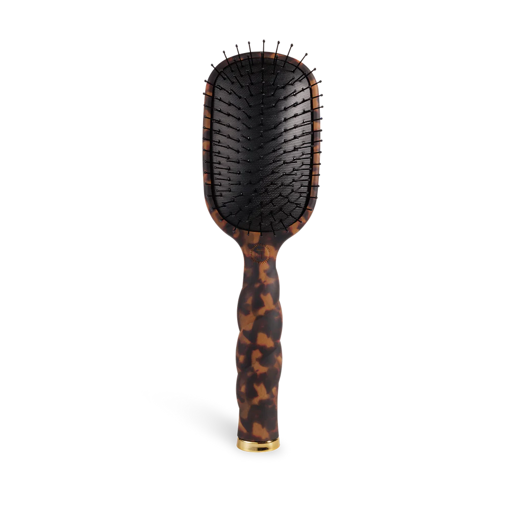 Hairbrush with tortoiseshell handle on a white background