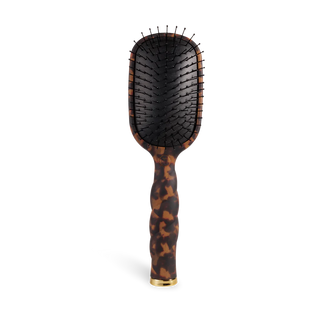Hairbrush with tortoiseshell handle on a white background