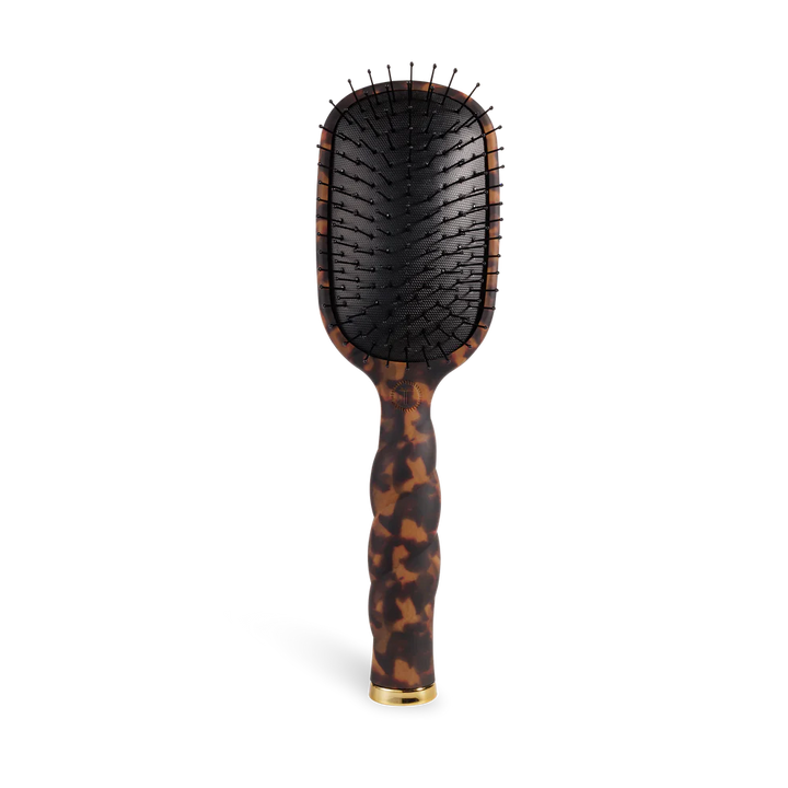 Hairbrush with tortoiseshell handle on a white background