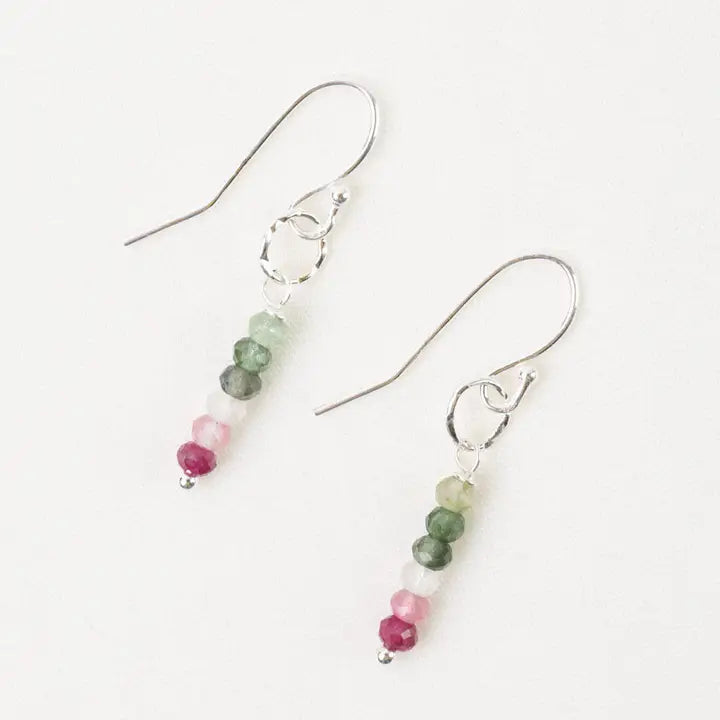 Pair of earrings with green and pink bead drops on a white background